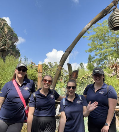 Four team members pose near Expedition Everest at Disney's Animal Kingdom